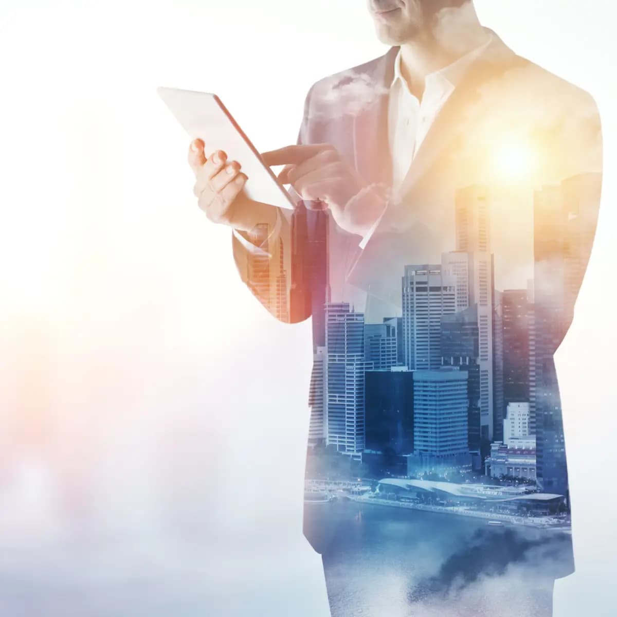 A premium man in a suit is holding a tablet in front of a city.